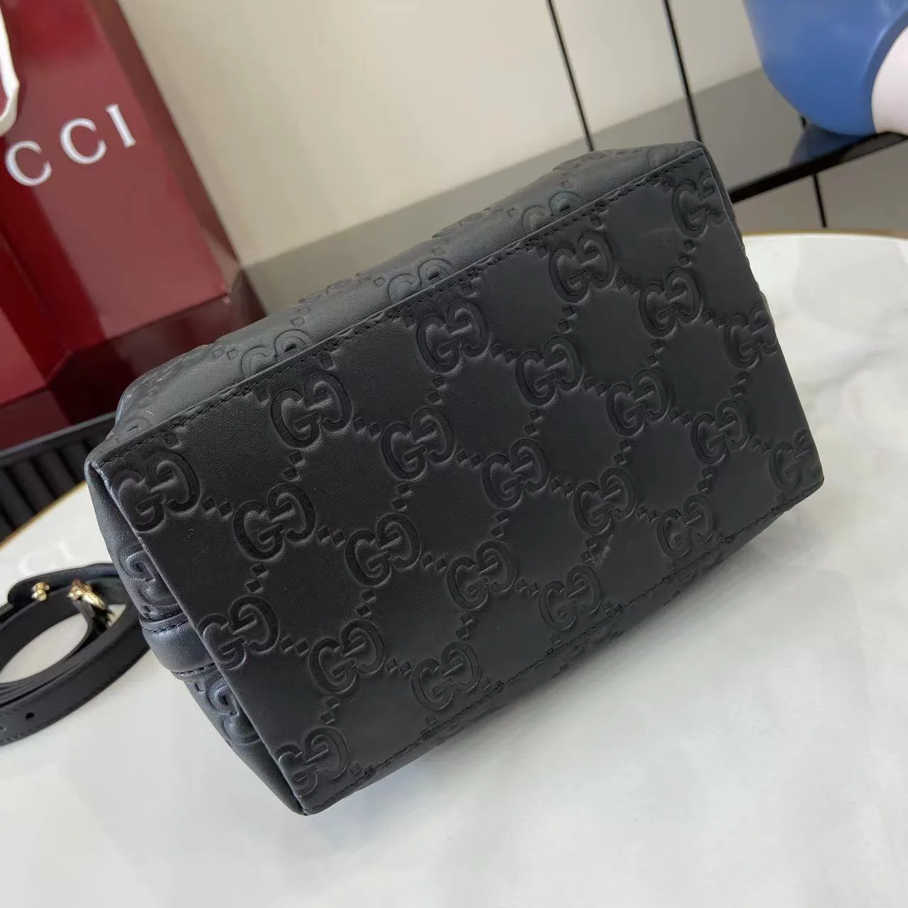 Gucci GG Emblem Small Bucket Bag GG Print Embossed Leather - Black