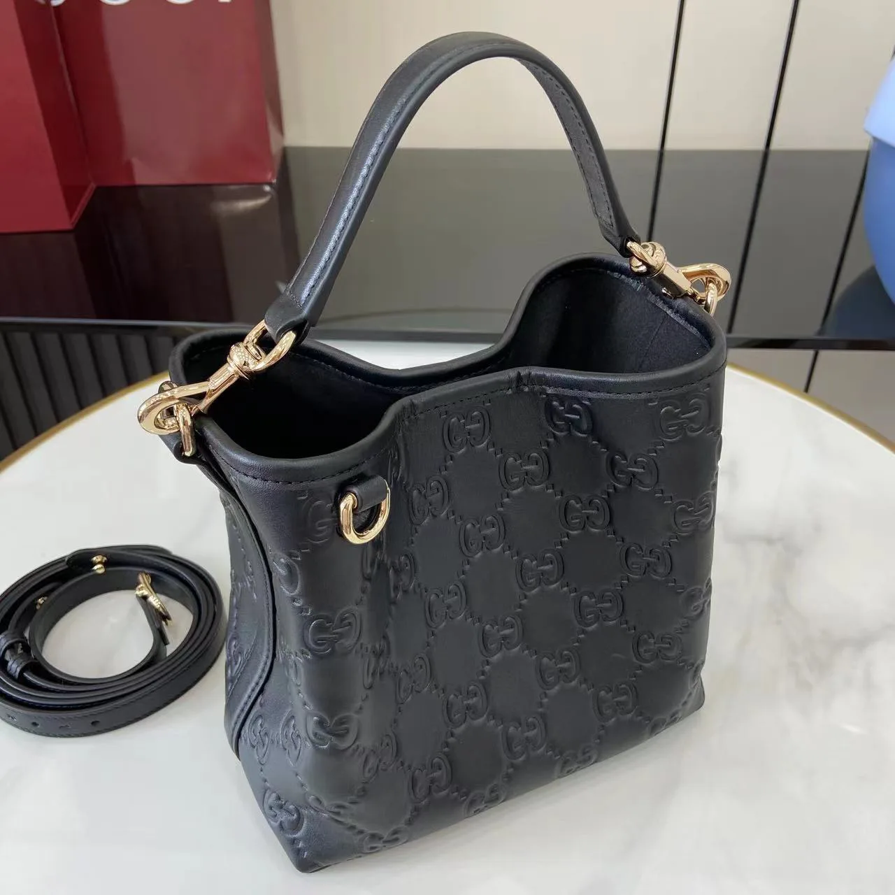 Gucci GG Emblem Small Bucket Bag GG Print Embossed Leather - Black